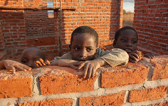 Kids Looking Over Wall